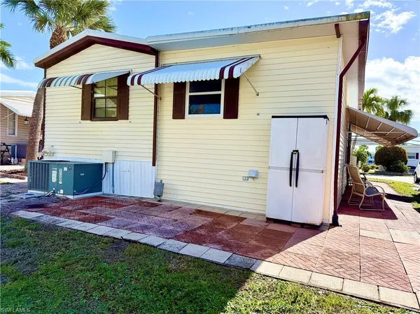 a view of backyard of house with entertaining space