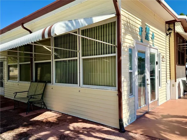 a view of a chair and table in the porch