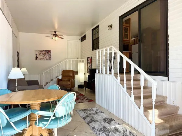 a view of a livingroom with furniture a rug and wooden floor
