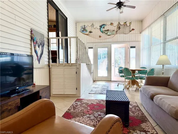 a living room with furniture a chandelier and a fireplace