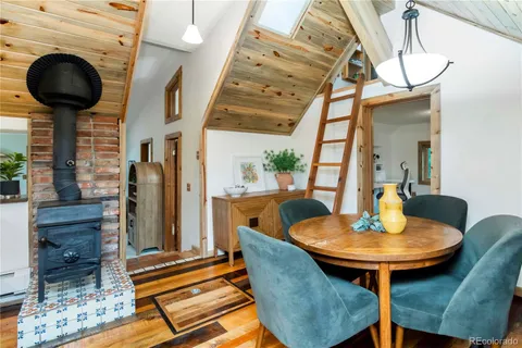 a dining room with furniture and wooden floor