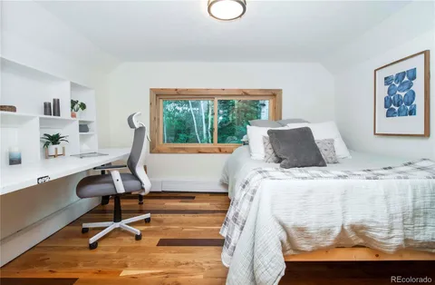 a bedroom with a bed and a large window