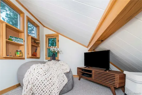 a bedroom with furniture and flat screen tv