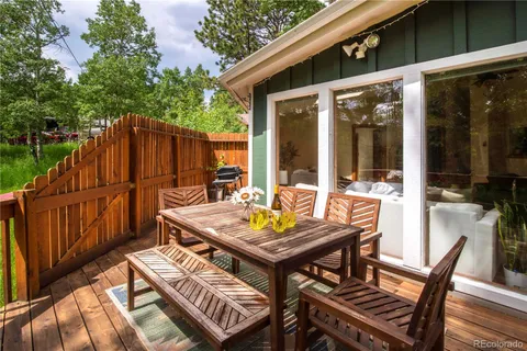 a view of a wooden bench on the roof deck
