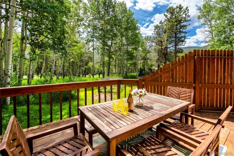 a view of a house with a big yard and large trees