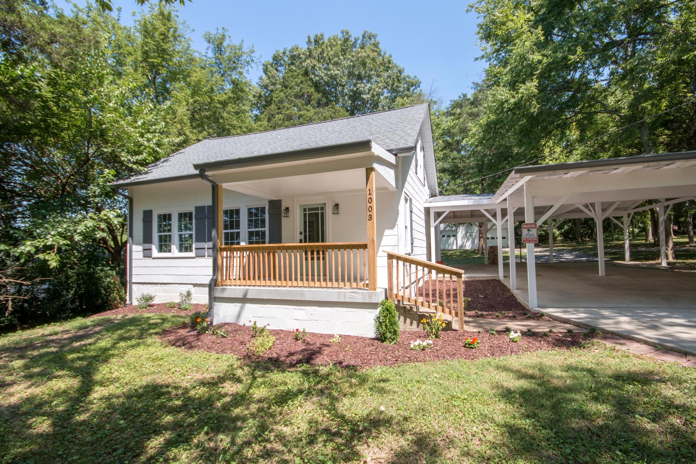 1003 Neelys Bend Road Madison, TN 37115 - Photo 1 of 30 a front view of a house with garden