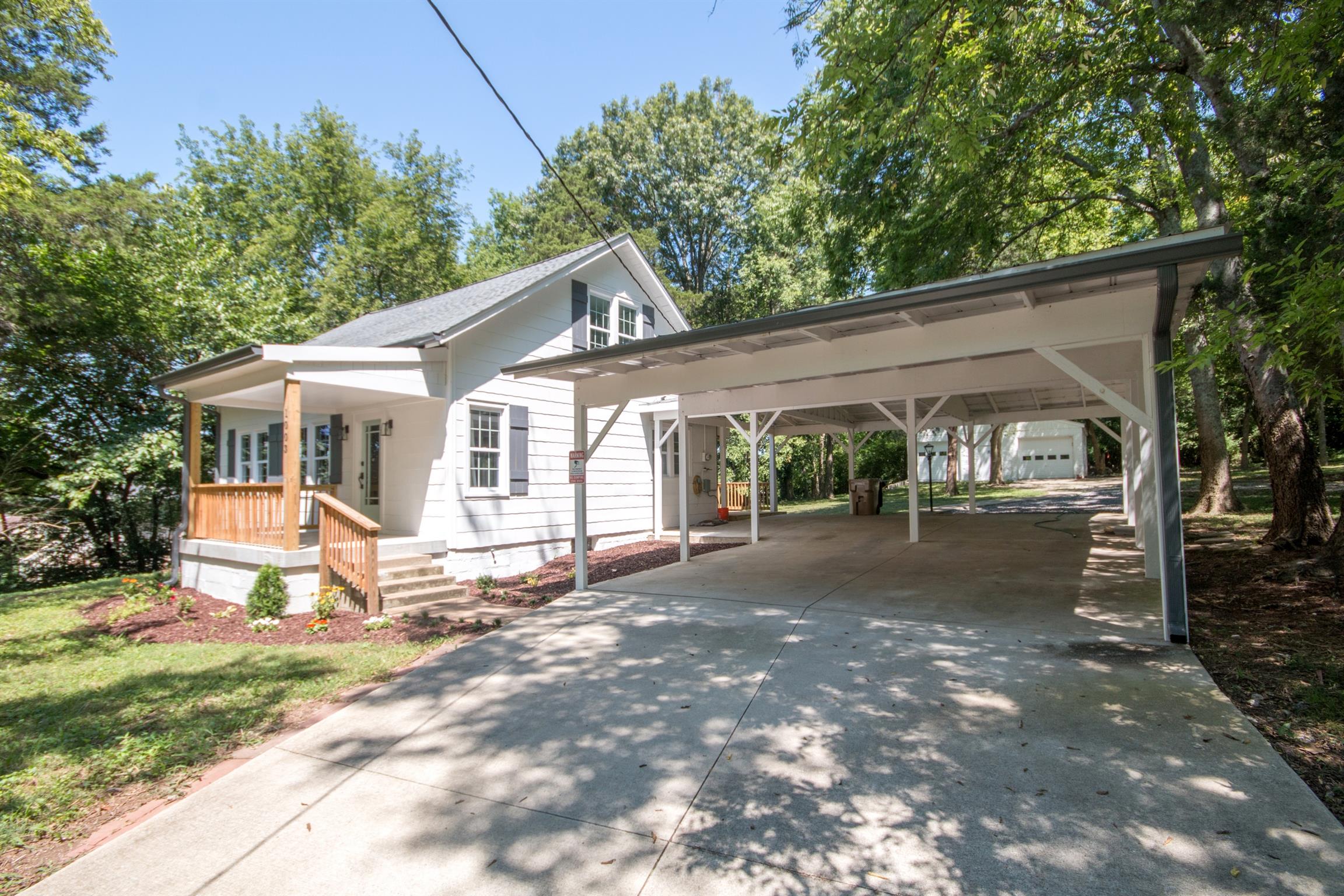 1003 Neelys Bend Road Madison, TN 37115 - Photo 2 of 30 a front view of a house with a yard and potted plants