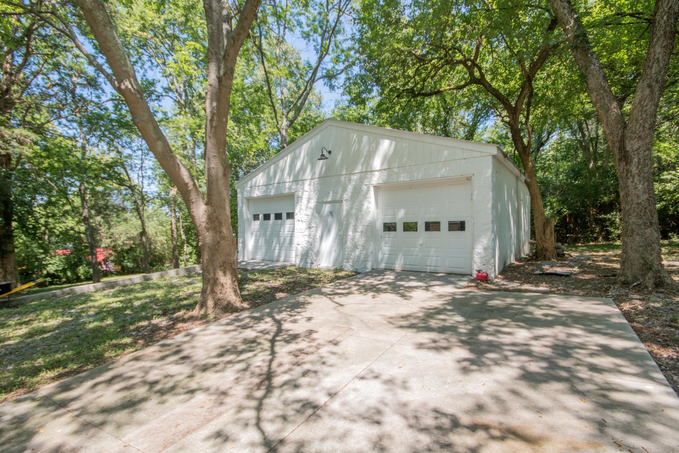 1003 Neelys Bend Road Madison, TN 37115 - Photo 27 of 30 a backyard of a house with a large tree