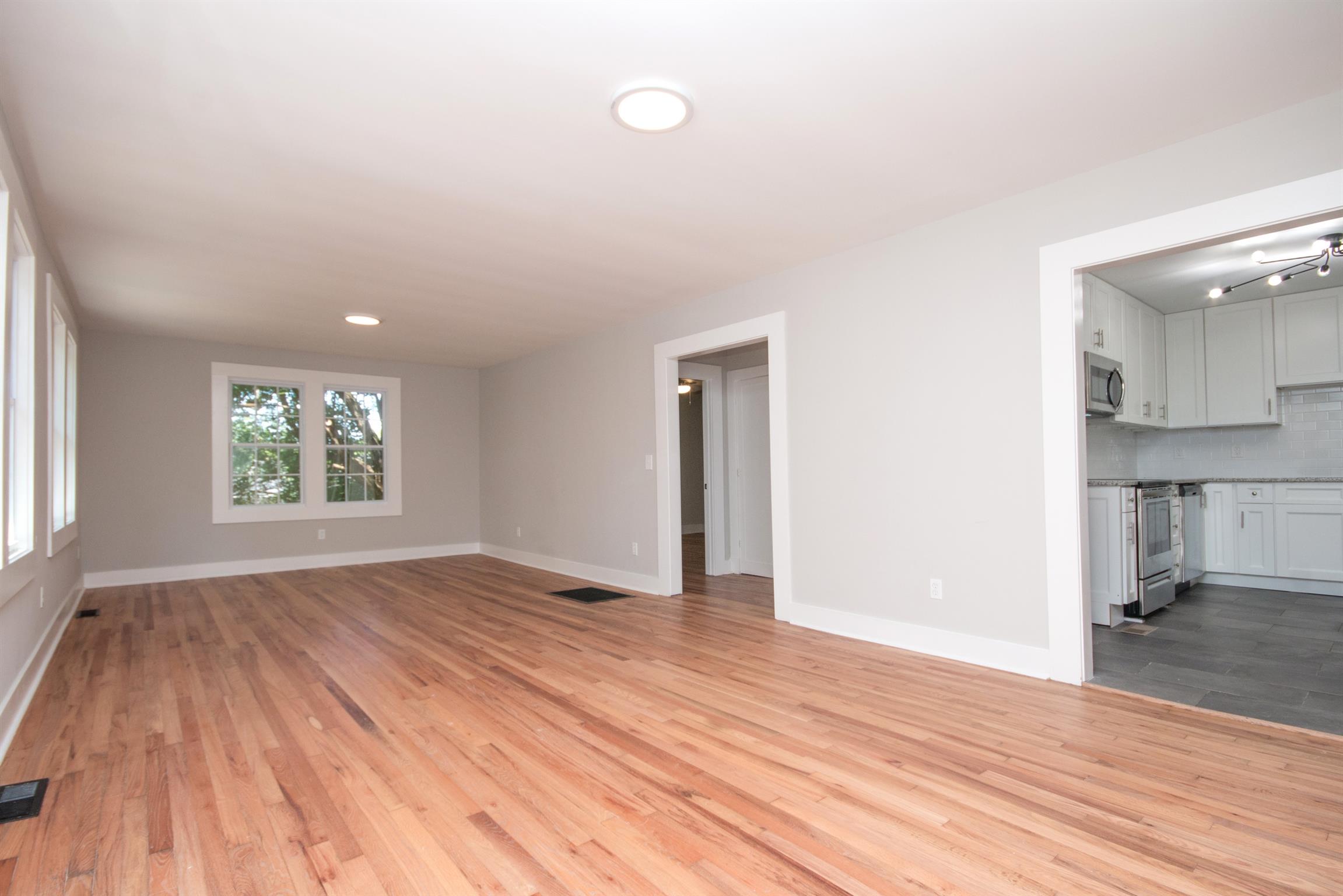 1003 Neelys Bend Road Madison, TN 37115 - Photo 4 of 30 a view of empty room with wooden floor and fan
