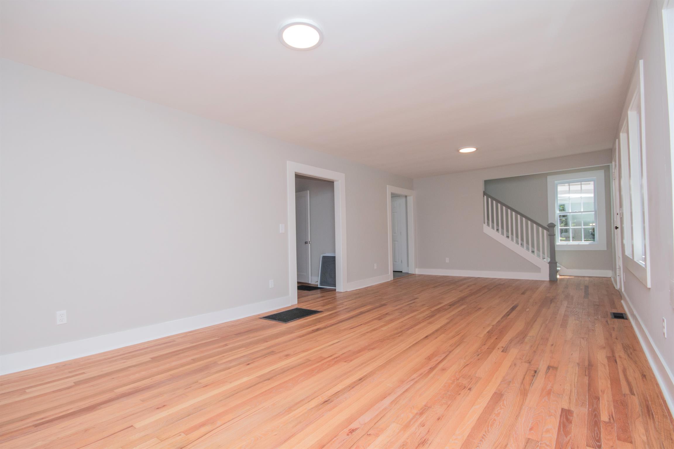1003 Neelys Bend Road Madison, TN 37115 - Photo 5 of 30 a view of an empty room with wooden floor and a window