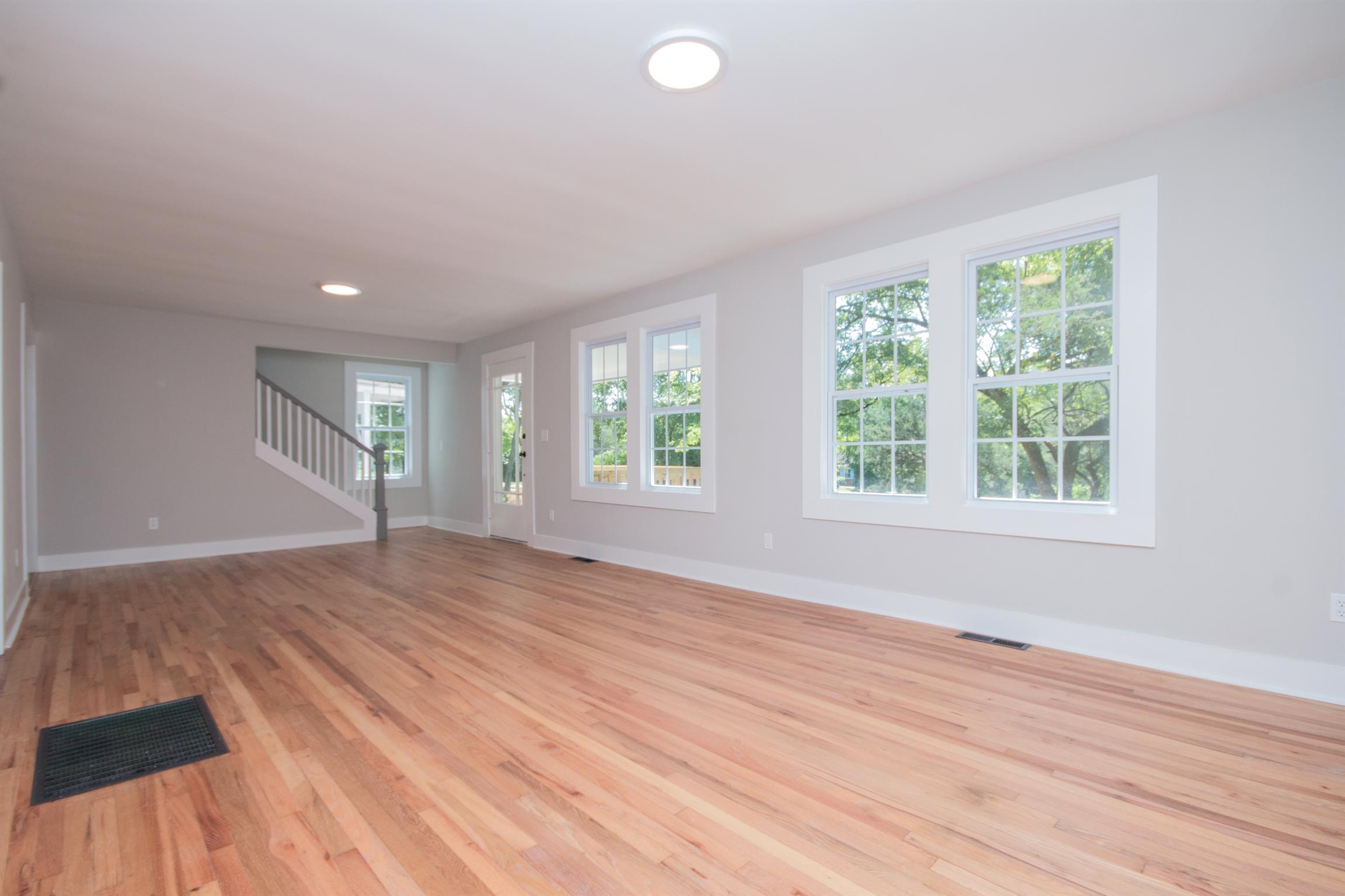 1003 Neelys Bend Road Madison, TN 37115 - Photo 6 of 30 an empty room with wooden floor and windows