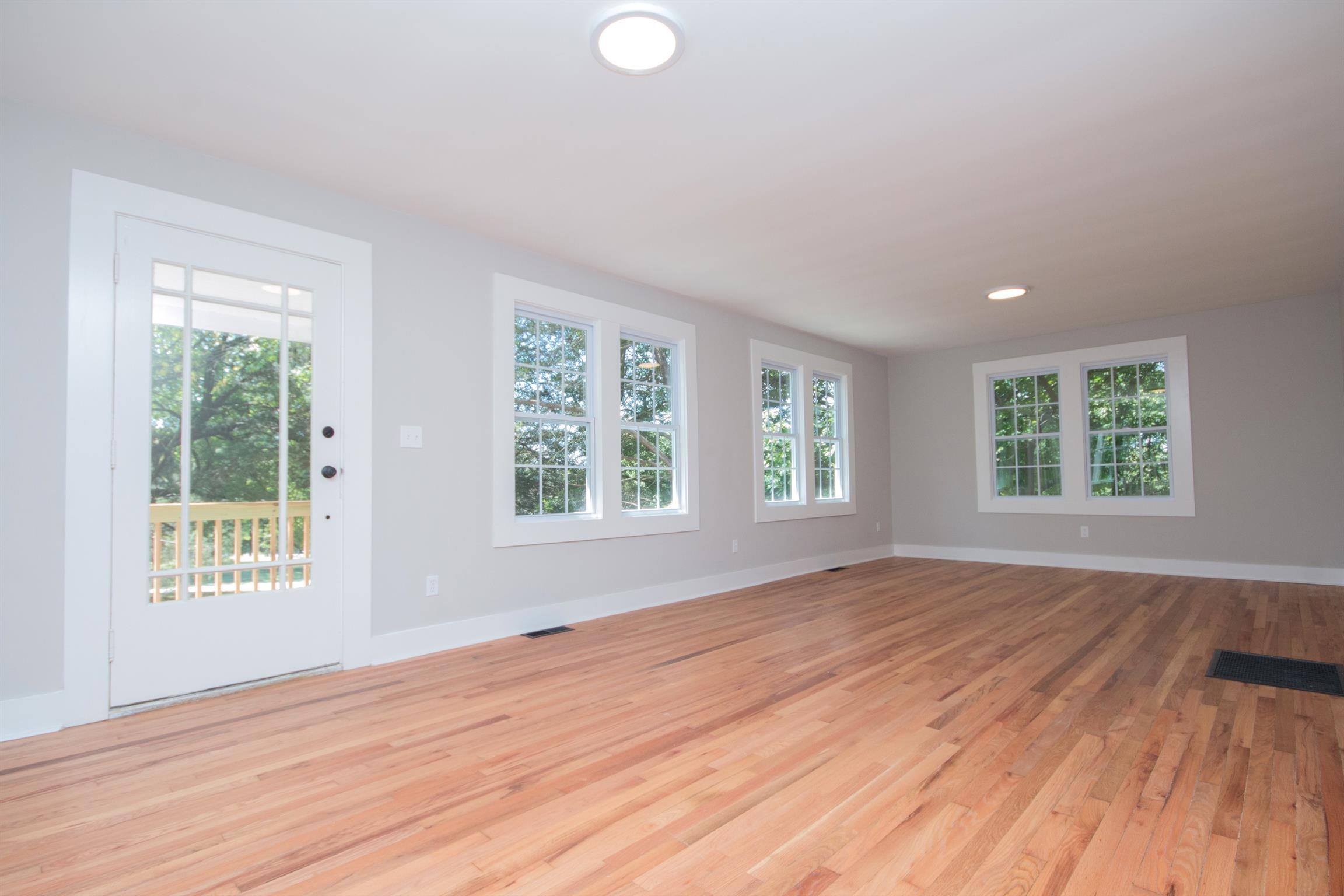 1003 Neelys Bend Road Madison, TN 37115 - Photo 7 of 30 a view of an empty room with wooden floor and a window