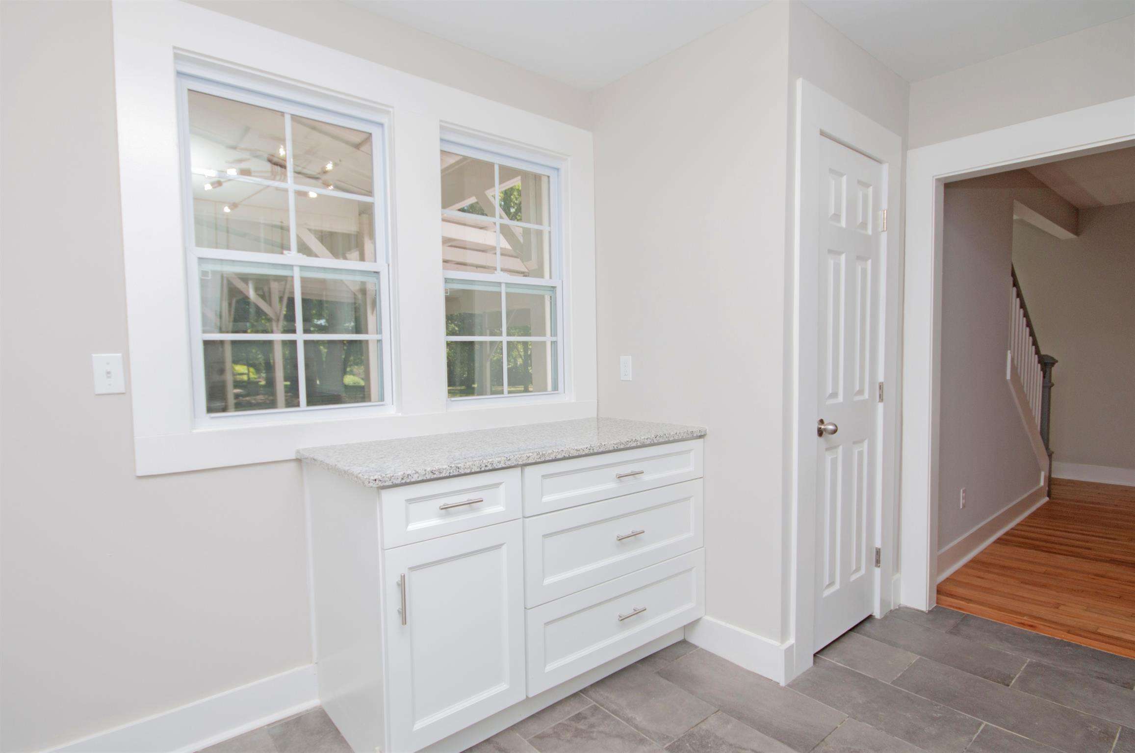 1003 Neelys Bend Road Madison, TN 37115 - Photo 10 of 30 a kitchen with white cabinets and window