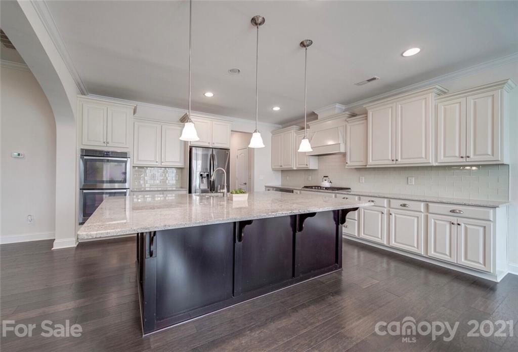 360 Monteray Oaks Circle Fort Mill, SC 29715 - Photo 11 of 44 a large kitchen with stainless steel appliances granite countertop a large counter top a sink and a refrigerator
