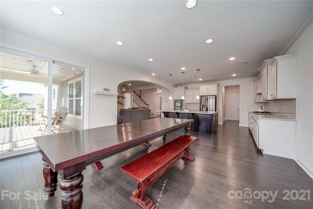360 Monteray Oaks Circle Fort Mill, SC 29715 - Photo 17 of 44 a room with stainless steel appliances lots of wooden furniture dining table and chairs