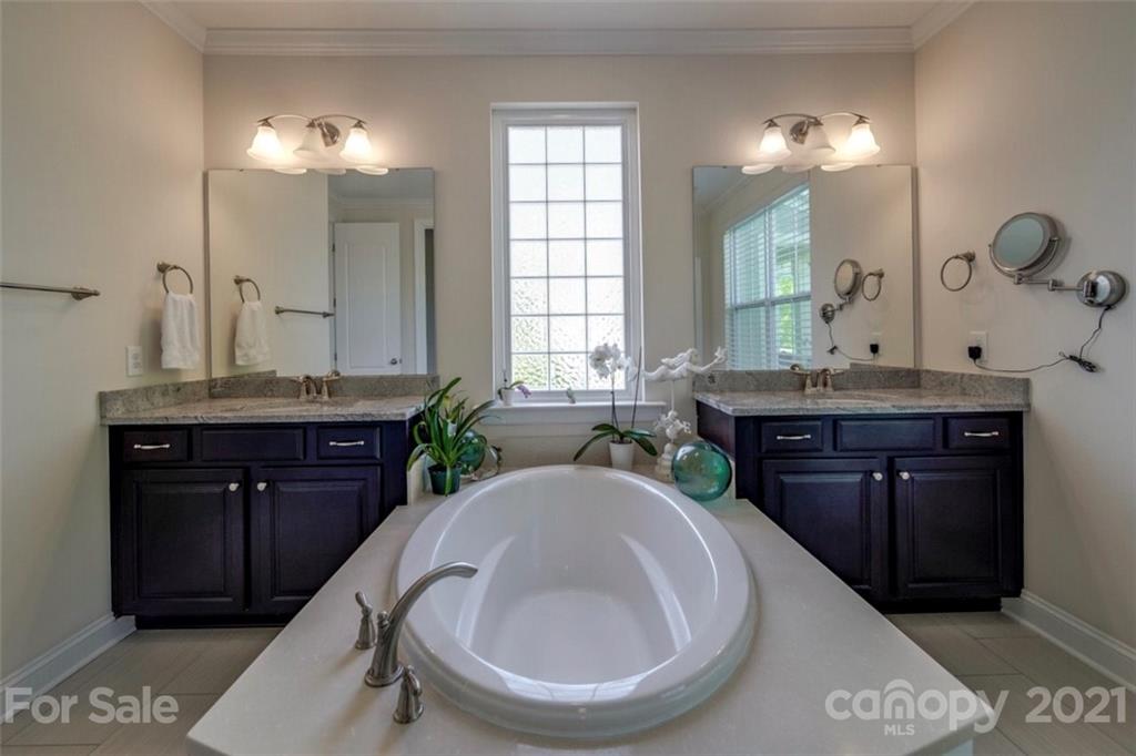 360 Monteray Oaks Circle Fort Mill, SC 29715 - Photo 25 of 44 a bathroom with a granite countertop sink a toilet and a mirror