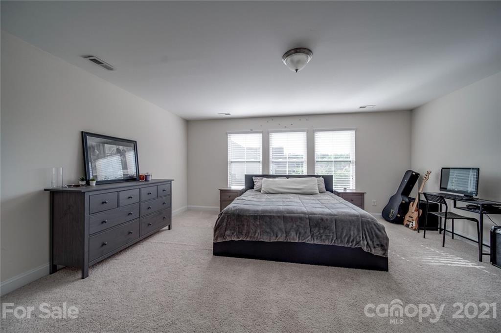 360 Monteray Oaks Circle Fort Mill, SC 29715 - Photo 31 of 44 a bedroom with a bed and a dresser