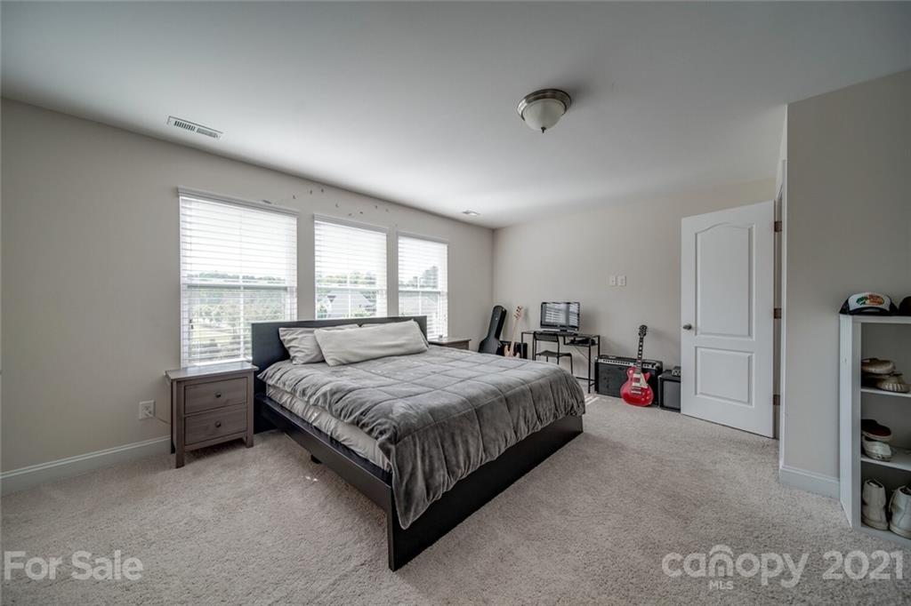 360 Monteray Oaks Circle Fort Mill, SC 29715 - Photo 32 of 44 a spacious bedroom with a bed table and a window