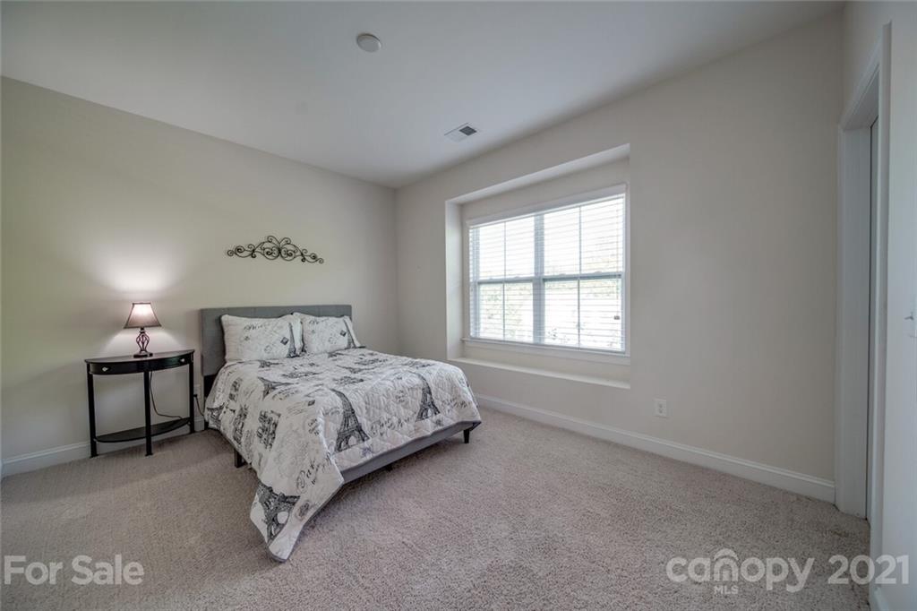 360 Monteray Oaks Circle Fort Mill, SC 29715 - Photo 34 of 44 a bedroom with a bed a table and windows