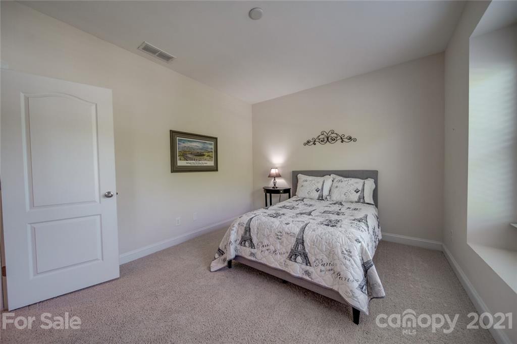 360 Monteray Oaks Circle Fort Mill, SC 29715 - Photo 35 of 44 a bedroom with a bed and a lamp