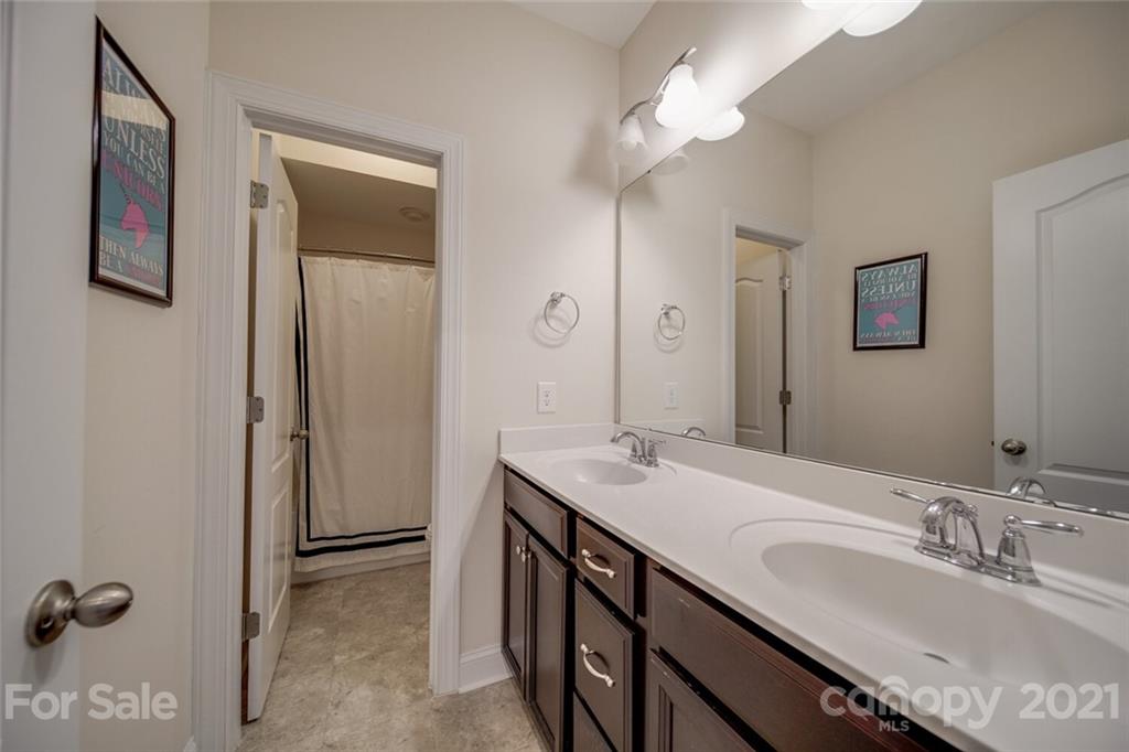 360 Monteray Oaks Circle Fort Mill, SC 29715 - Photo 36 of 44 a bathroom with a double vanity sink a mirror and a shower