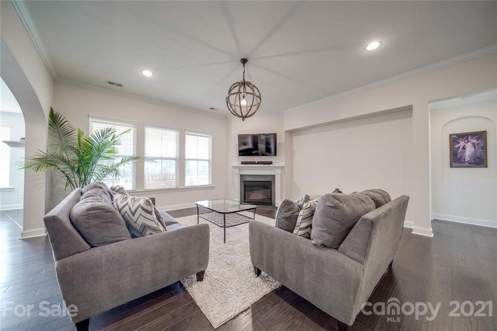 360 Monteray Oaks Circle Fort Mill, SC 29715 - Photo 9 of 44 a living room with furniture a window and a clock