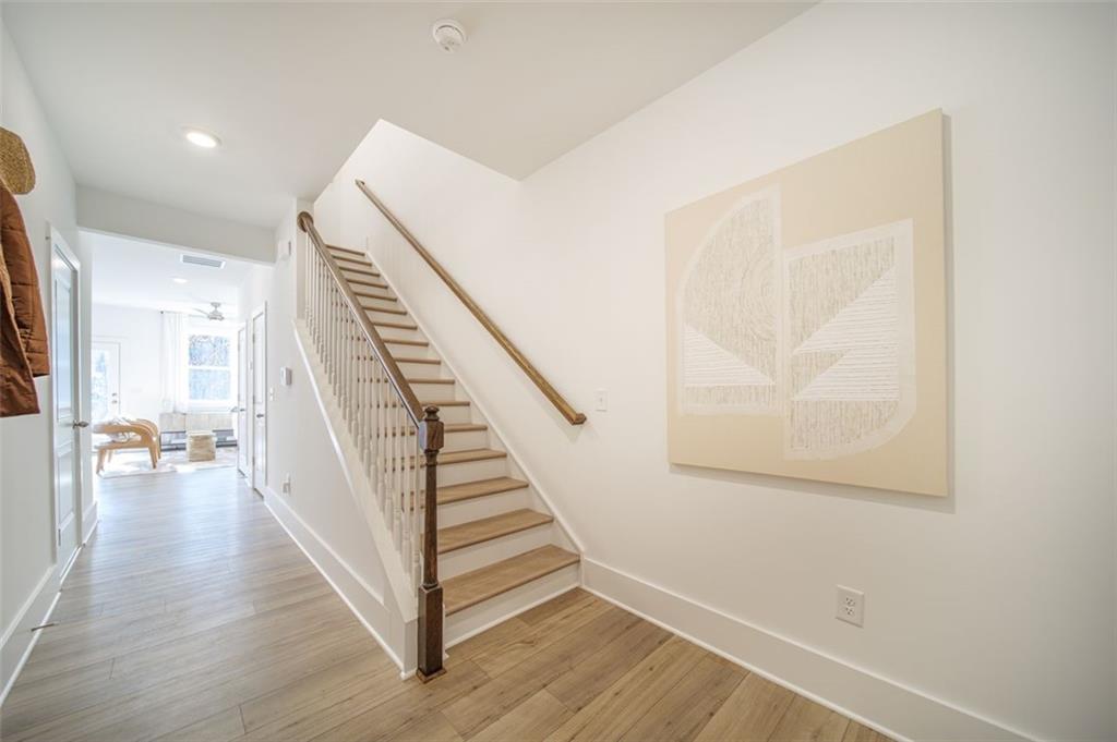 1654 Florence Run Northwest Atlanta, GA 30318 - Photo 22 of 41 a view of a hallway with wooden floor and stairs