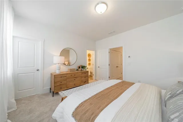 a bedroom with a bed and a dresser