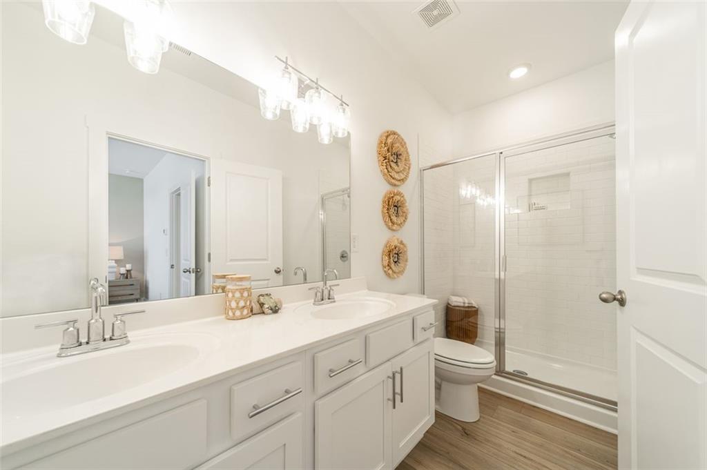 1654 Florence Run Northwest Atlanta, GA 30318 - Photo 24 of 41 a bathroom with a double vanity sink mirror and toilet