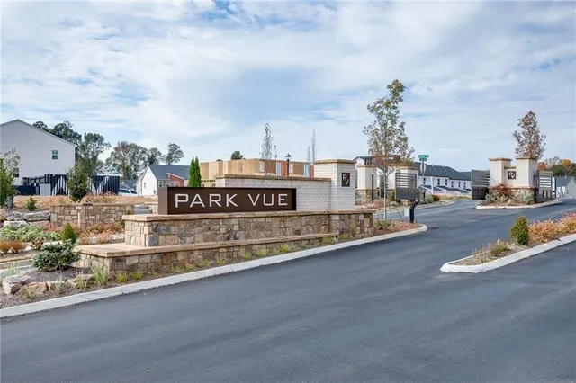 a view of a pathway with a wrought fence