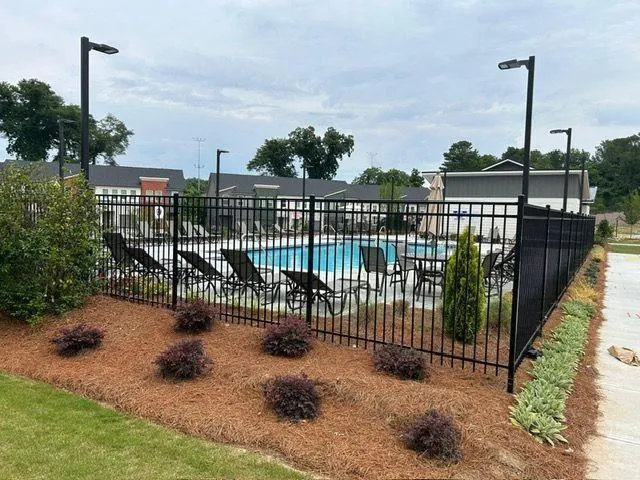 a view of a swimming pool with outdoor seating