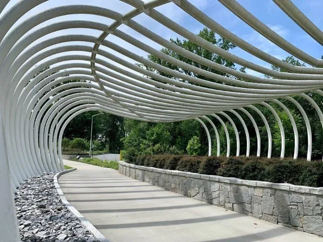an aerial view of a house with a garden and lake view