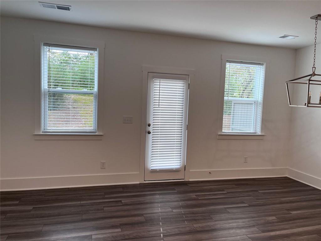 1654 Florence Run Northwest Atlanta, GA 30318 - Photo 6 of 41 a view of an empty room with wooden floor and a window