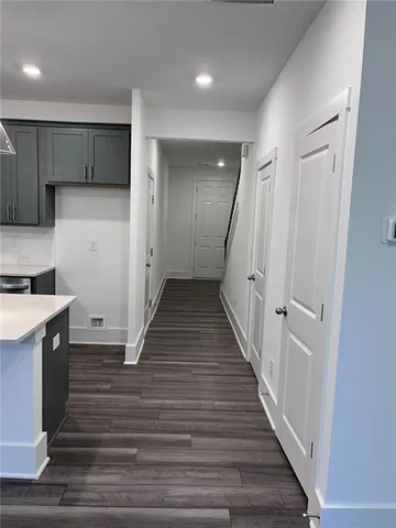 a kitchen with a refrigerator and white cabinets