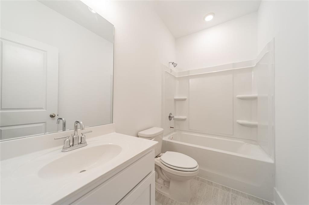 1654 Florence Run Northwest Atlanta, GA 30318 - Photo 9 of 41 a bathroom with a sink a toilet and shower
