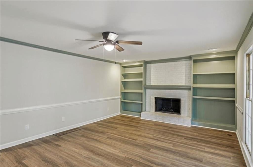 141 Patterson Road Southwest Lawrenceville, GA 30044 - Photo 11 of 34 a view of an empty room with a fireplace and a ceiling fan