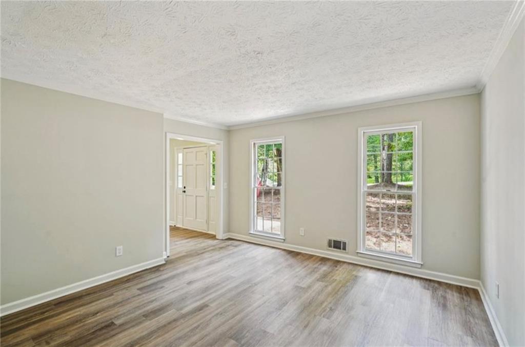 141 Patterson Road Southwest Lawrenceville, GA 30044 - Photo 25 of 34 an empty room with wooden floor and windows