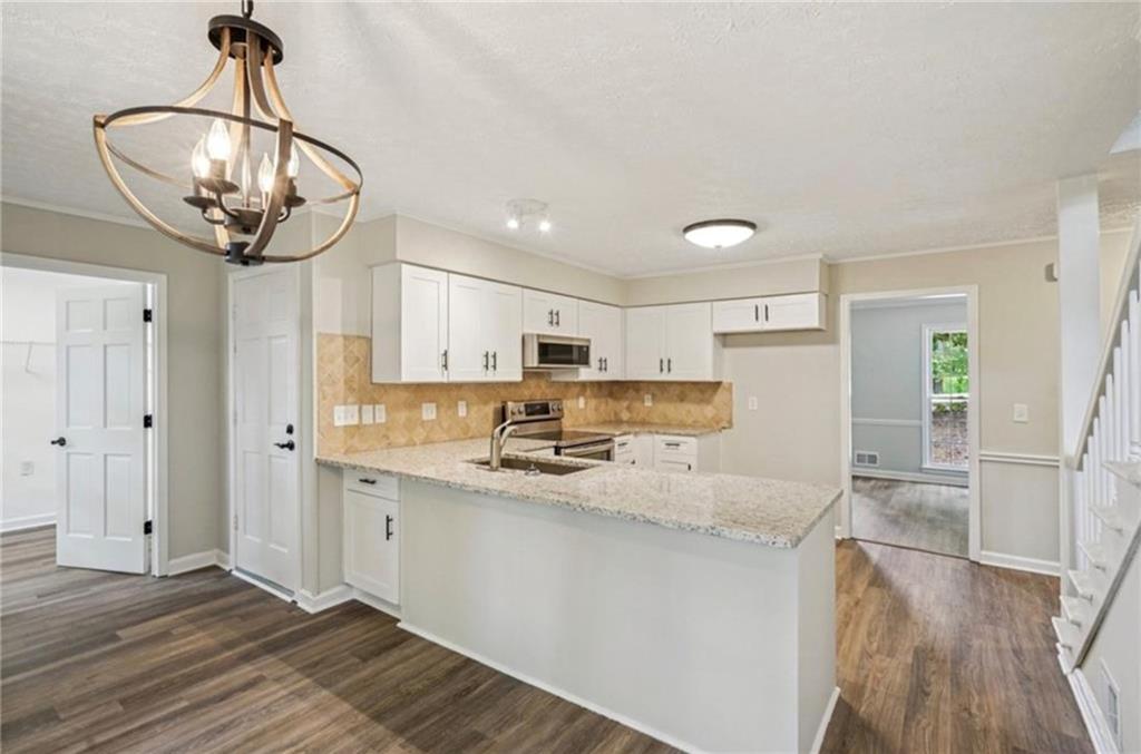 141 Patterson Road Southwest Lawrenceville, GA 30044 - Photo 8 of 34 a kitchen with stainless steel appliances granite countertop a sink refrigerator and cabinets