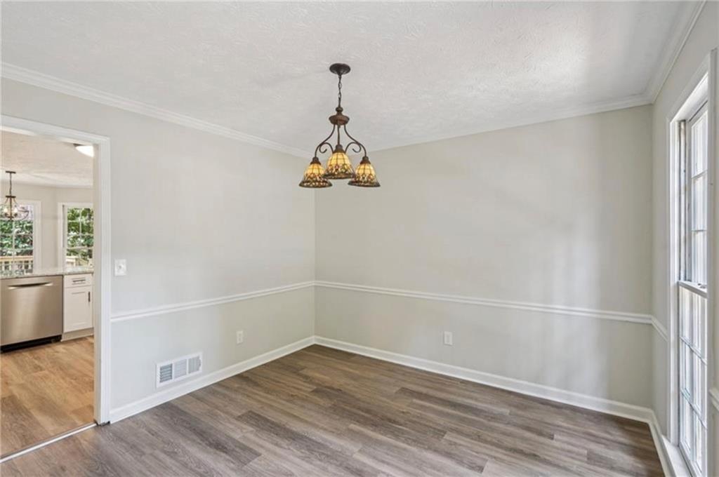 141 Patterson Road Southwest Lawrenceville, GA 30044 - Photo 9 of 34 a view of an empty room with wooden floor and a window