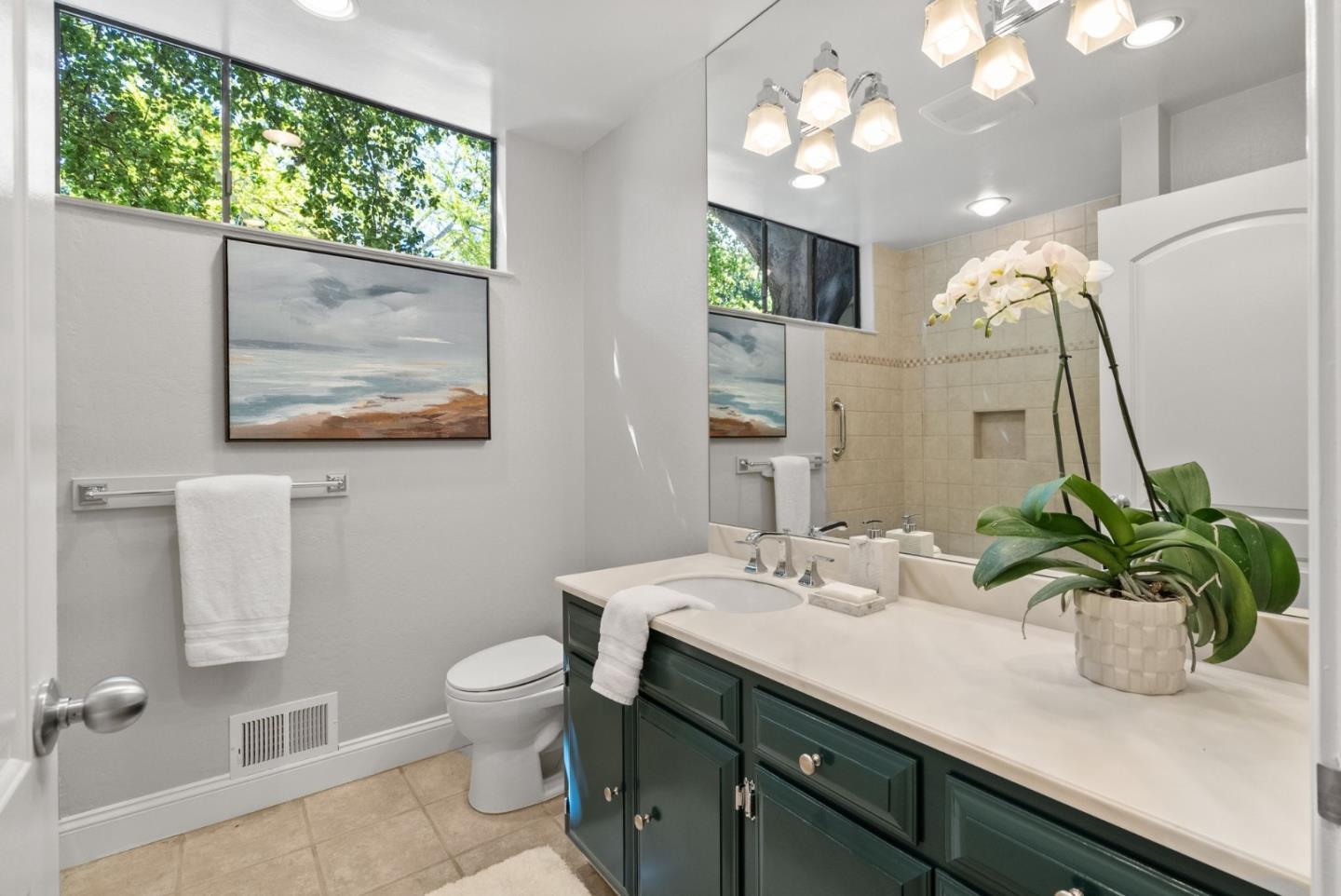 886 Berkeley Avenue Menlo Park, CA 94025 - Photo 13 of 46 a bathroom with a sink a toilet and a large mirror