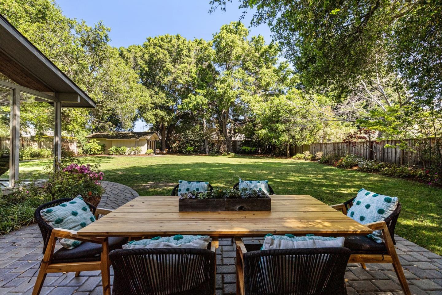 886 Berkeley Avenue Menlo Park, CA 94025 - Photo 23 of 46 a view of a table and chairs in back yard of the house