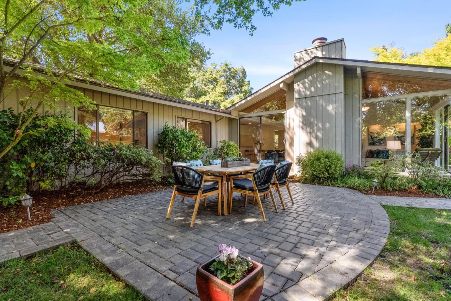886 Berkeley Avenue Menlo Park, CA 94025 - Photo 27 of 46 a view of a patio with table and chairs potted plants and floor to ceiling window