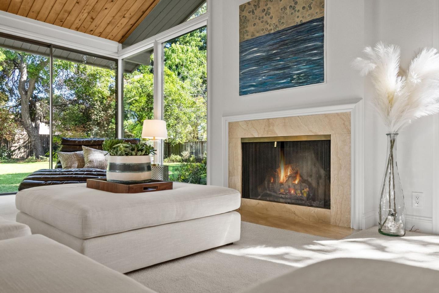886 Berkeley Avenue Menlo Park, CA 94025 - Photo 5 of 46 a living room with furniture a fireplace and a floor to ceiling window