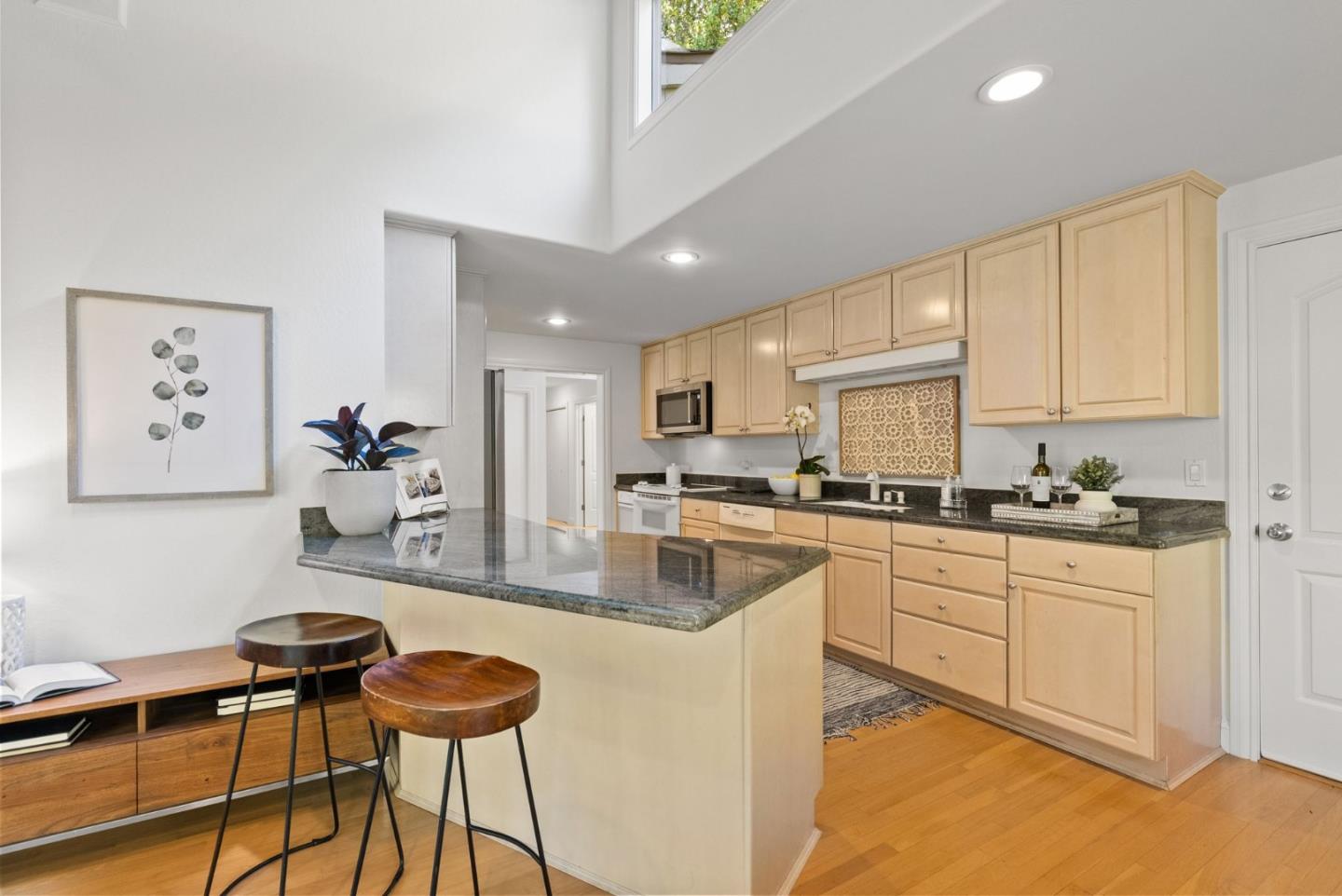 886 Berkeley Avenue Menlo Park, CA 94025 - Photo 7 of 46 a kitchen with stainless steel appliances granite countertop a stove a sink dishwasher and a refrigerator with wooden floor