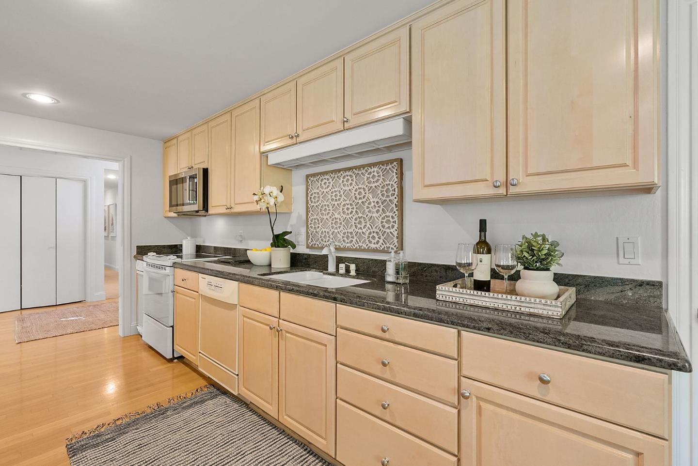 886 Berkeley Avenue Menlo Park, CA 94025 - Photo 9 of 46 a kitchen with granite countertop white cabinets and white appliances