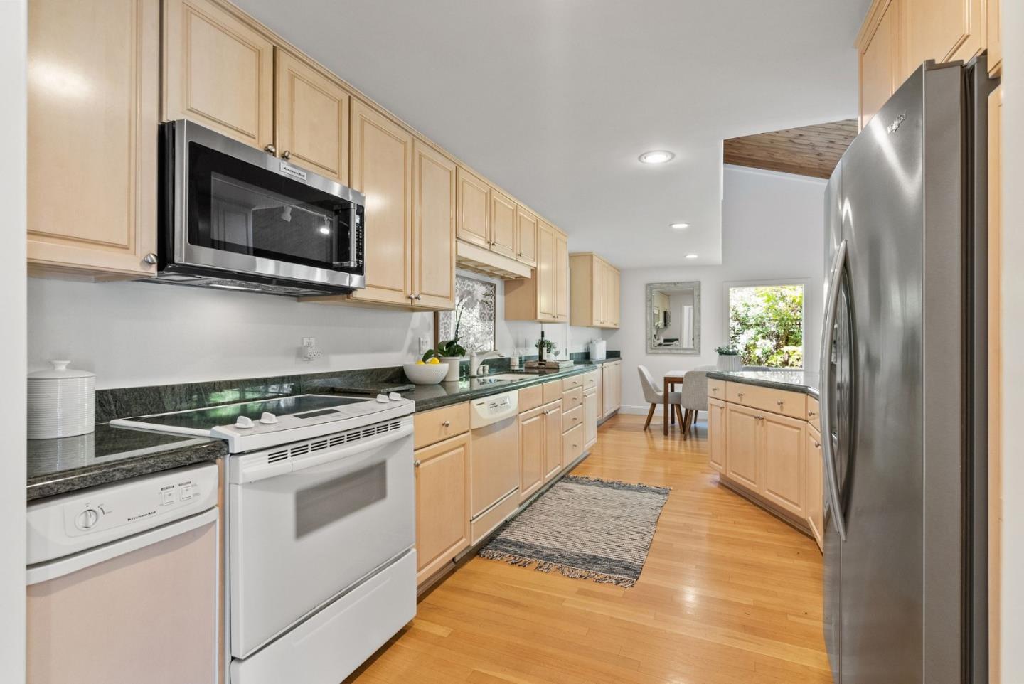 886 Berkeley Avenue Menlo Park, CA 94025 - Photo 10 of 46 a kitchen with stainless steel appliances granite countertop a refrigerator a stove top oven a sink and dishwasher