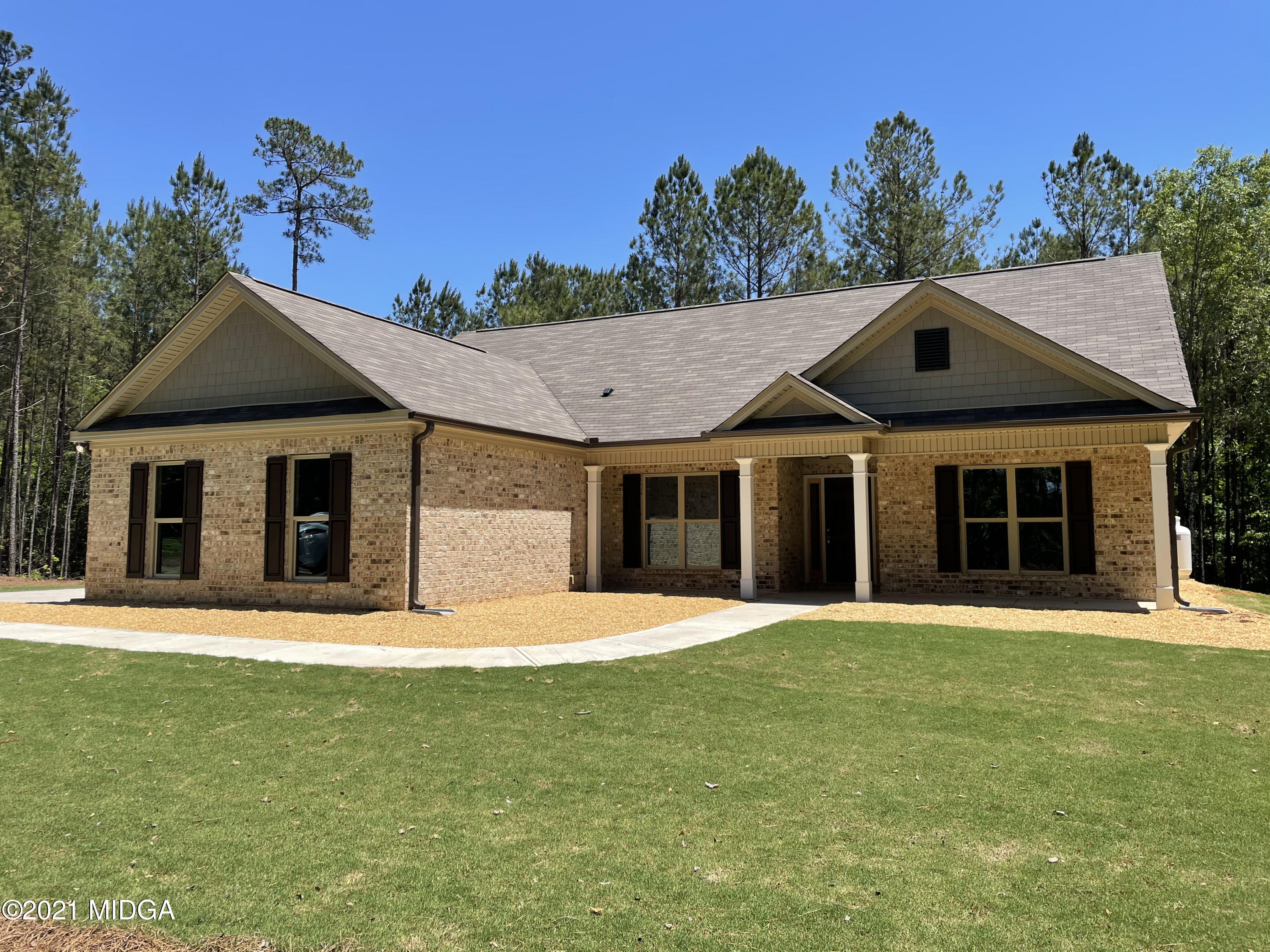 249 Castleberry Road Forsyth, GA 31029 - Photo 2 of 5 a front view of a house with a garden