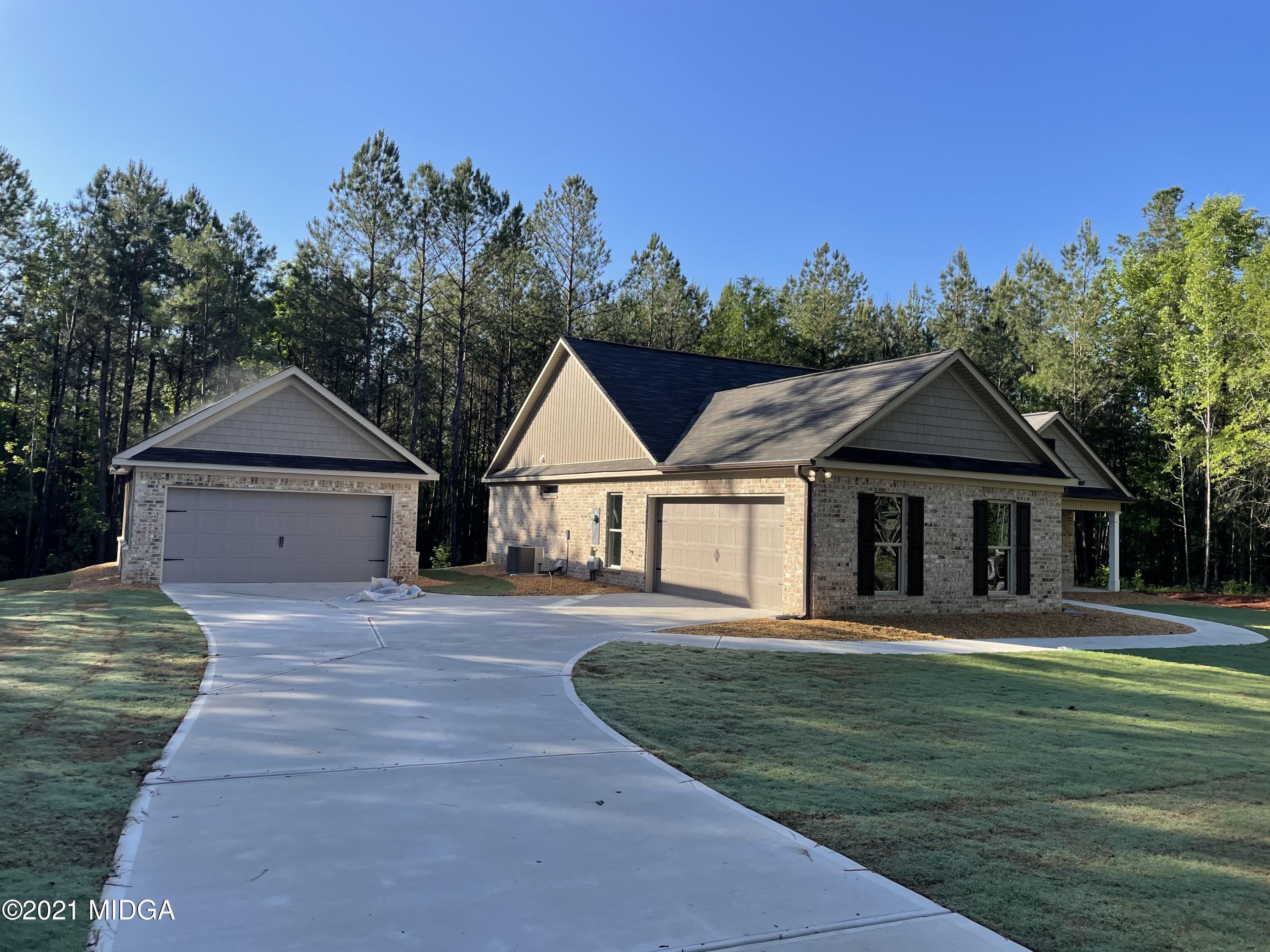 249 Castleberry Road Forsyth, GA 31029 - Photo 3 of 5 a front view of a house with a yard and trees