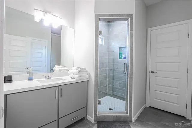 a bathroom with a double vanity sink and mirror