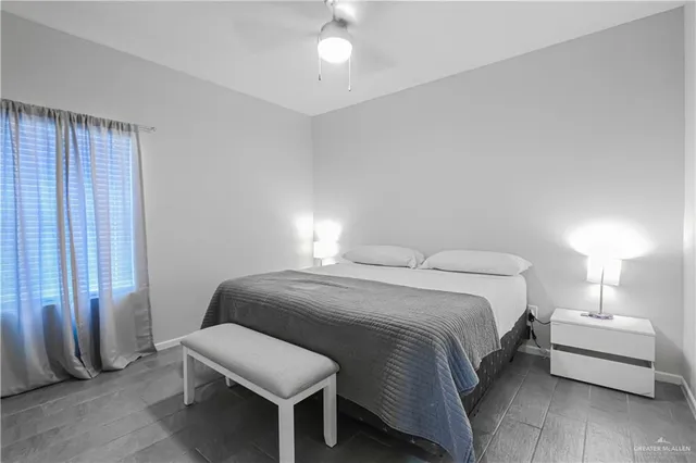 a bedroom with a bed and a lamp